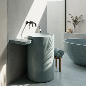 Oasis freestanding concrete basin SNK140 in Sea Shade colour with full-length integrated side shelf and organic cylinder form against dark wall
