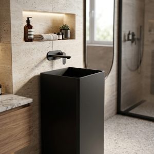 Matte black freestanding stainless steel square pedestal basin in luxury bathroom with travertine wall cladding oval mirror and matte black wall-mounted faucet