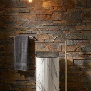 White Satvario glass pedestal freestanding basin with crystal clear glass bowl on White Satvario marble effect column pedestal in dark luxury bathroom