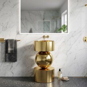 Orb Gold freestanding stainless steel pedestal basin featuring a reflective gold sphere suspended between brushed gold cylindrical sections in a luxury designer bathroom