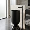 Wine Glass Black freestanding stainless steel pedestal basin with wide matte black cylinder bowl on smoked dome base and gunmetal floor faucet in dark contemporary bathroom