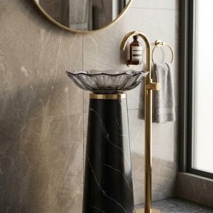 Muniq black marble effect resin freestanding basin with smoked petal crystal bowl and brushed gold waist ring in luxury bathroom with stone wall cladding polished gold floor tap and gold mirror