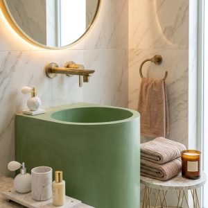 Close-up of smooth pigmented sage green handcrafted concrete surface on Aquilo countertop cylinder basin SNK130