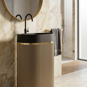 Close-up of deep matte black oval bowl and precision gold ring accent on Muniq artificial stone pedestal basin 1341 warm sand fluted oval column washbasin