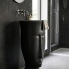 Muniq artificial stone face sculpture basin 1312 400x860mm showing abstract modernist face form in flawless deep matte black engineered stone with open oval bowl at the crown