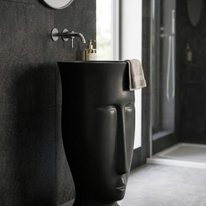 Muniq artificial stone face sculpture basin 1312 400x860mm showing abstract modernist face form in flawless deep matte black engineered stone with open oval bowl at the crown