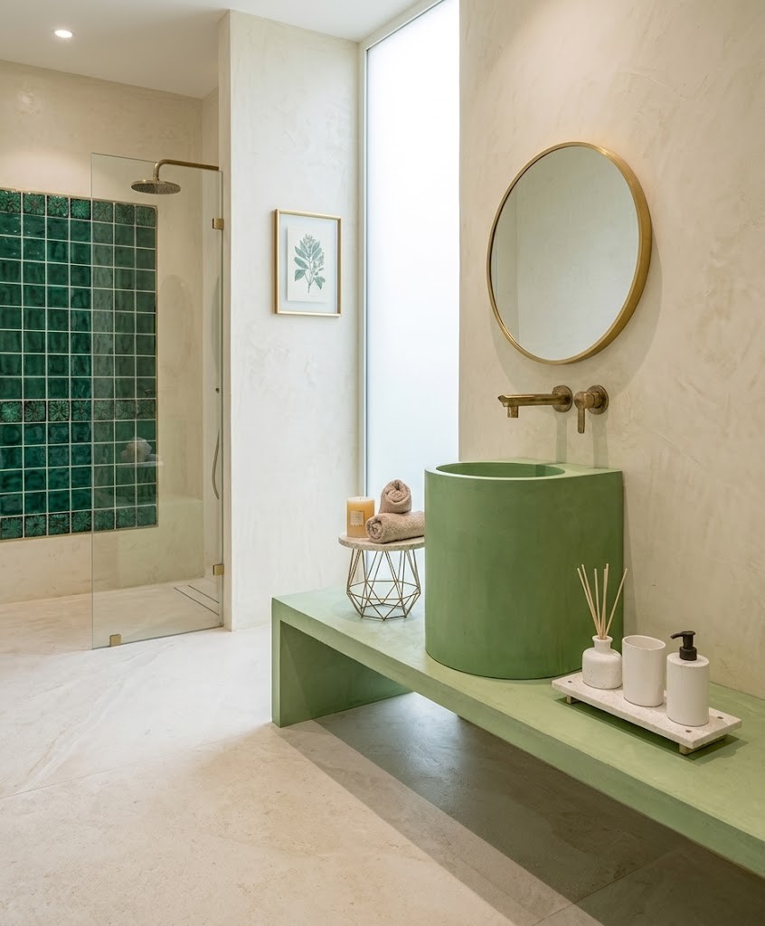 Aquilo Countertop Concrete Cylinder Basin SNK130 Sage Green Vanity Bathroom Sink Aquilo countertop concrete cylinder basin SNK130 in sage green on matching concrete vanity surface in luxury bathroom with emerald green wall tiles and gold fixtures
