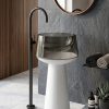 Transparent Pedestal freestanding resin basin with dramatic smoked glass effect translucent resin bowl on white tapered pedestal and matte black floor faucet in minimalist bathroom
