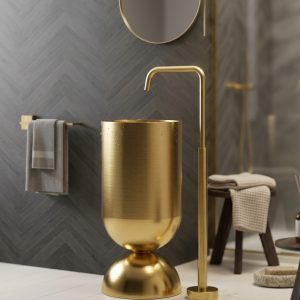 Wine Glass Gold freestanding stainless steel pedestal basin with brushed gold cylinder bowl on polished gold dome base and gold floor faucet in dark luxury bathroom