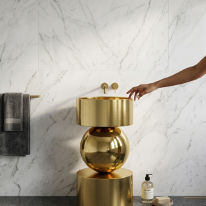 Close-up of mirror-polished gold sphere centerpiece on Orb Gold freestanding stainless steel pedestal basin showing luxury reflective finish