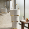 White marble cylindrical pedestal washbasin with two gold brass ring bands and brushed gold faucet in a luxury bathroom