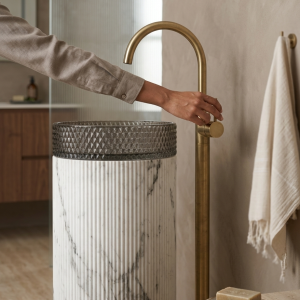 Close-up of premium crystal clear glass bowl on White Satvario glass pedestal freestanding basin showing transparency and light refraction