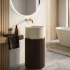 Grey artificial stone freestanding fluted square pedestal basin 1321 with deep vertical ribbed texture on all four faces and black wall-mounted faucet against blue striped wall