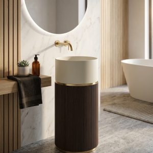 Grey artificial stone freestanding fluted square pedestal basin 1321 with deep vertical ribbed texture on all four faces and black wall-mounted faucet against blue striped wall