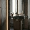 Muniq artificial stone pedestal basin 1314 450x860mm showing deep mocha bronze fluted cylinder pedestal with wide matte black bowl overhang silhouette luxury bathroom washbasin