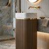 Muniq artificial stone pedestal basin 1343 600x375x850mm showing warm bronze tan fluted oval column pedestal with clean white oval bowl and precision gold ring accent classical luxury washbasin