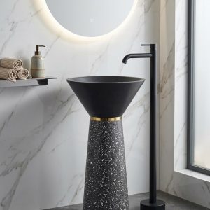 Muniq artificial stone pedestal basin 1328 500x850mm showing grey terrazzo effect tapered column pedestal with matte black flared cone bowl and precision gold ring accent industrial luxury washbasin