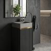 Grey artificial stone freestanding fluted square pedestal basin 1321 with deep vertical ribbed texture on all four faces and black wall-mounted faucet against blue striped wall