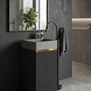 Grey artificial stone freestanding fluted square pedestal basin 1321 with deep vertical ribbed texture on all four faces and black wall-mounted faucet against blue striped wall