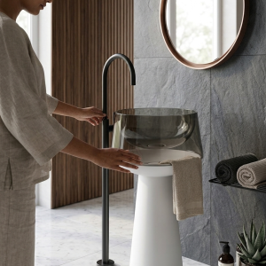Close-up of smoked glass effect translucent deep grey resin bowl on Transparent Pedestal freestanding luxury bathroom washbasin