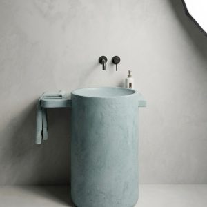 Close-up of seamless junction between full-length integrated concrete side shelf and organic cylinder basin on Oasis SNK140 freestanding washbasin