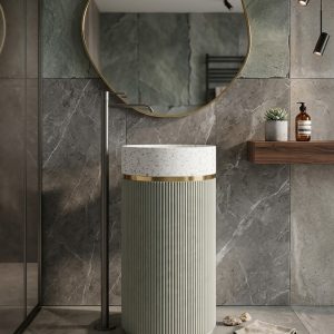 Muniq artificial stone pedestal basin 1304 400x860mm showing sage green fluted cylinder pedestal with white terrazzo effect bowl and gold ring accent in contemporary bathroom