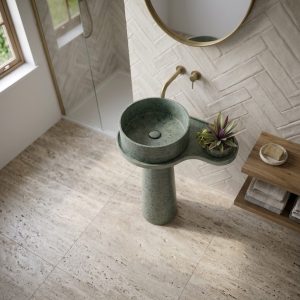 Contemporary round composite stone basin in a sage green finish with minimalist luxury styling.