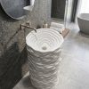 Canyon Pearl freestanding artificial stone pedestal basin featuring flowing layered contours and premium matte white finish inspired by natural stone formations