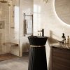 Noir Halo freestanding artificial stone pedestal basin featuring a matte black finish, vertical fluted detailing, and luxury gold accent ring