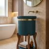 Luxury teal composite stone basin featuring vertical fluted detailing, brass accent band, and designer wooden stand with storage she