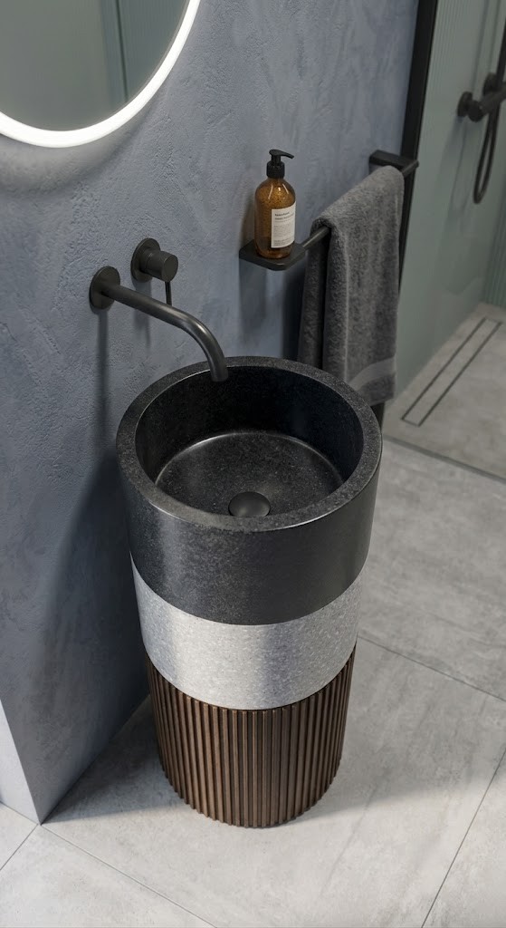 Close-up view of decorative vertical fluting on the pedestal base of a contemporary composite stone basin.