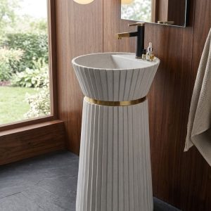Ivory Crown freestanding artificial stone pedestal basin featuring a matte white finish, vertical fluted detailing, and elegant gold accent ring