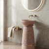 Blush pink terrazzo composite stone freestanding basin with textured pedestal design and elegant gold accent ring.