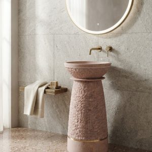 Blush pink terrazzo composite stone freestanding basin with textured pedestal design and elegant gold accent ring.