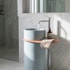 Sky blue composite stone freestanding basin featuring an integrated side shelf and modern cylindrical pedestal design.