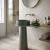 Sage green composite stone freestanding basin featuring an integrated side shelf and tapered pedestal design.
