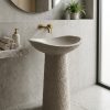 Luxury composite stone freestanding basin featuring an asymmetrical bowl and hand-carved textured pedestal design.