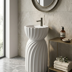 Twista Pearl freestanding artificial stone pedestal basin featuring elegant spiral fluted detailing and a premium matte white finish in a luxury bathroom setting