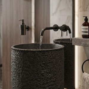 Close-up view of the handcrafted textured finish on a premium black composite stone washbasin.