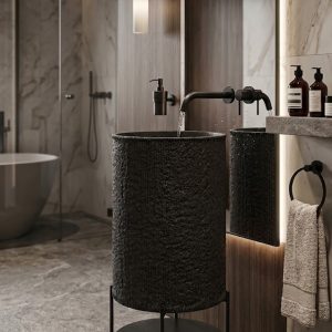 Luxury black composite stone pedestal basin featuring a textured exterior and minimalist metal stand with storage shelf.