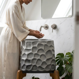 Close-up view of pebble-inspired textured surface on a luxury composite stone vessel washbasin.
