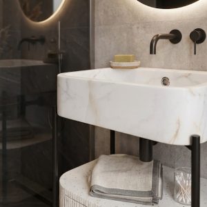Designer bathroom vanity cabinet featuring decorative textured detailing and integrated storage drawer.