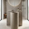 Ivory beige composite stone freestanding pedestal basin with hand-carved overlapping scale texture and cylindrical designer washbasin shape.