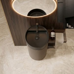 Close-up of polished gold stripe accent between matte black bowl and fine-ribbed warm bronze column on artificial stone pedestal basin 1359