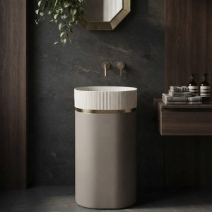 Modern composite stone freestanding basin featuring a fluted upper bowl, smooth cylindrical pedestal, and elegant gold accent ring.