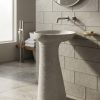 Twisted fluted composite stone freestanding basin with sculptural spiral pedestal and wide contemporary bowl.