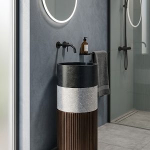 Luxury composite stone freestanding basin featuring a dark vessel bowl, contrasting stone band, and fluted pedestal base.