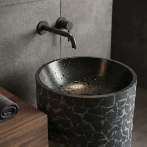 Close-up of fragmented mosaic pattern on black composite stone freestanding washbasin showing intricate geometric detailing.