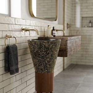 Decorative composite stone pedestal basin featuring artistic spiral patterns and an elegant wooden stand.